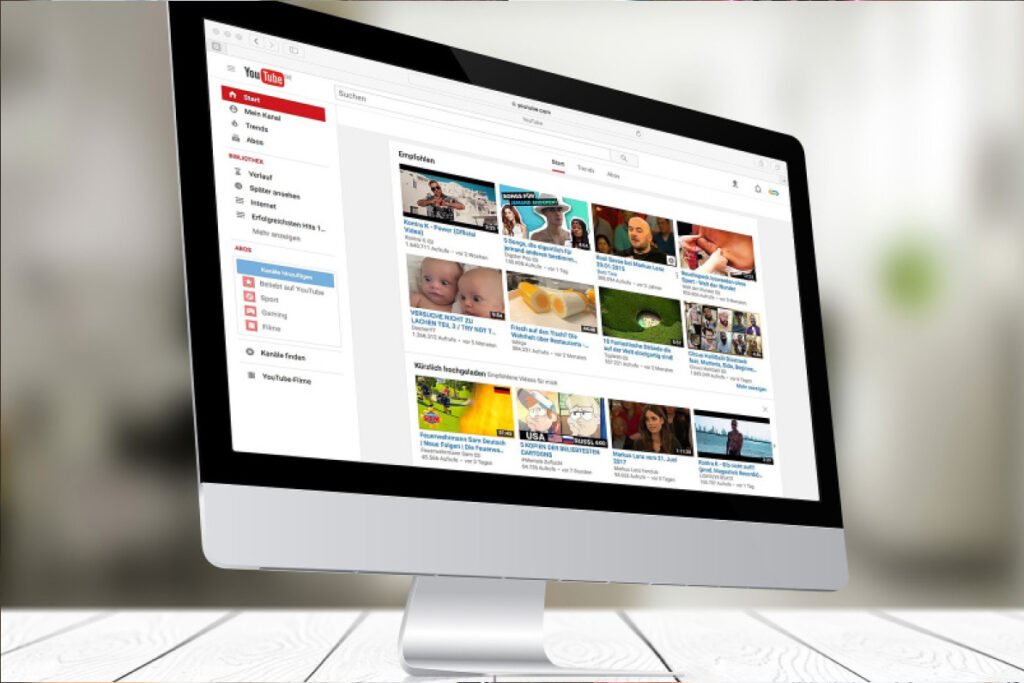 Desktop with YouTube page. Optimize your YouTube channel setup with Touchstorm's 4-month package including channel audit, growth plan & Topic Finder research.